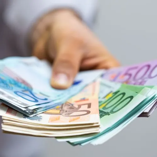 Mann hält diverse Euro-Banknoten in der Hand